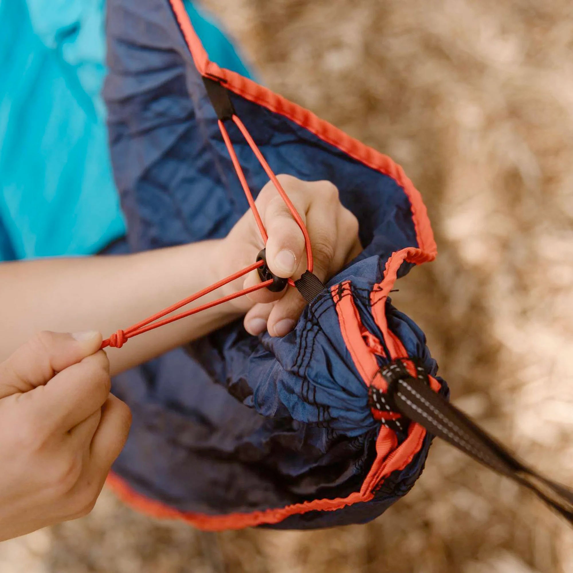 GrandTrunk ROVR™ Hanging Chair hammock in a cozy outdoor setting with vibrant colors and sturdy design.