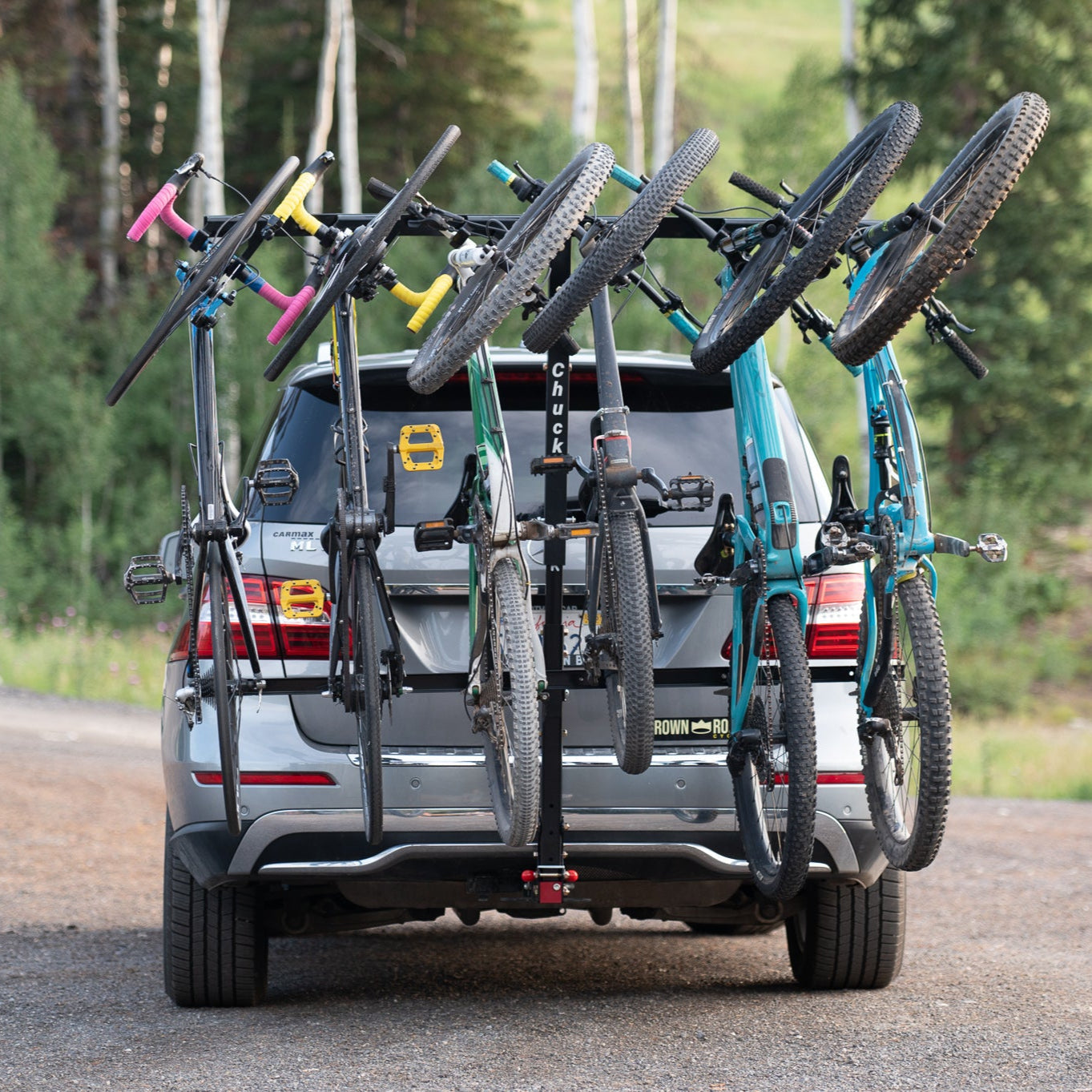 Chuck 4-bike vertical hitch rack attached to a vehicle, showing the sturdy metal frame and bike support arms.