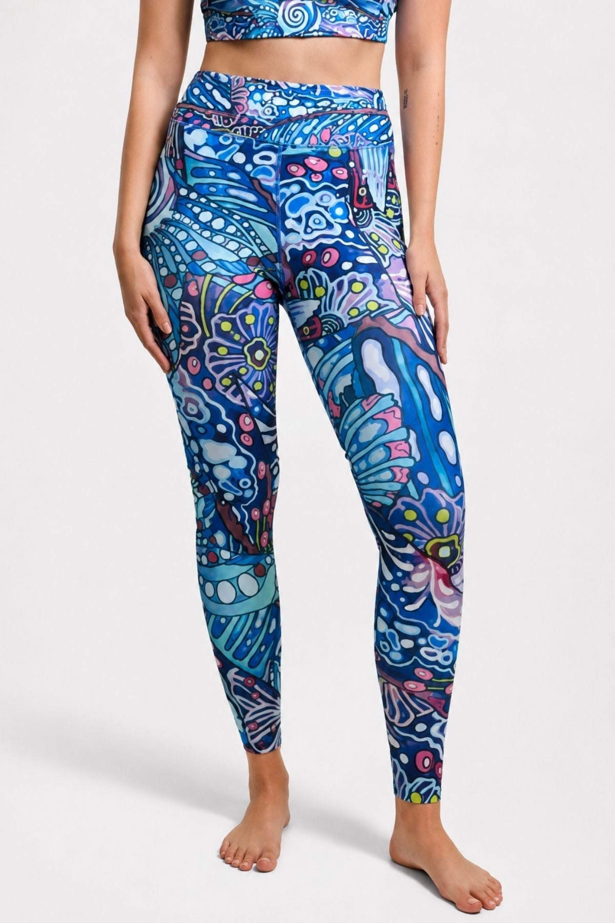 FisheWear Enchanted Grayling high-waisted leggings with a colorful rainbow ridge pattern, shown on a model.