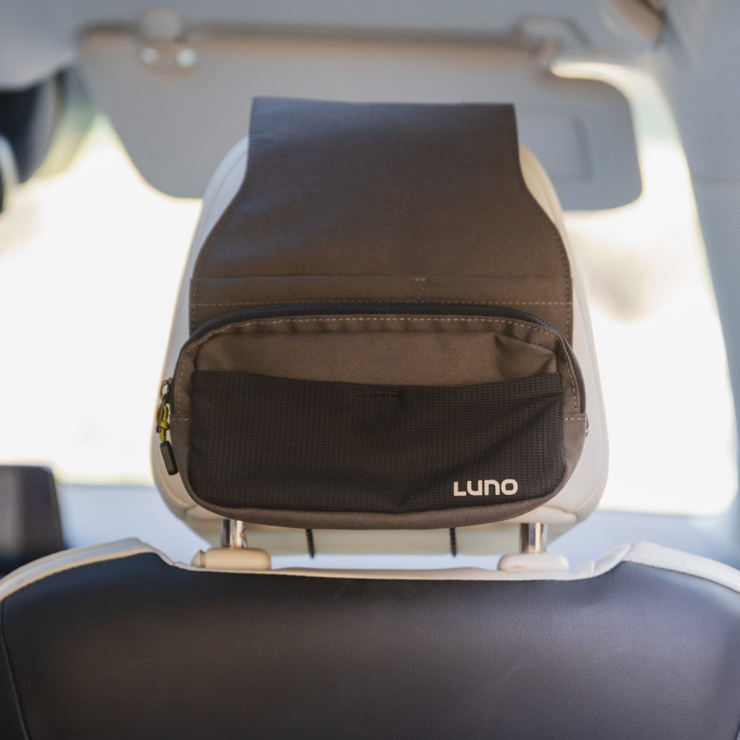 Luno® headrest organizer featuring multiple pockets for convenient storage in a car interior.