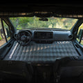 Inflatable mattress in the back of a vehicle with 'Luno' branding 