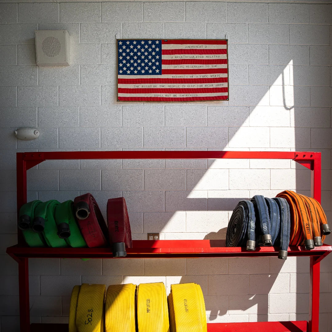 Recycled Firefighter American flag fire hose wall art featuring the Second Amendment in bold lettering, crafted from recycled firefighter hoses.