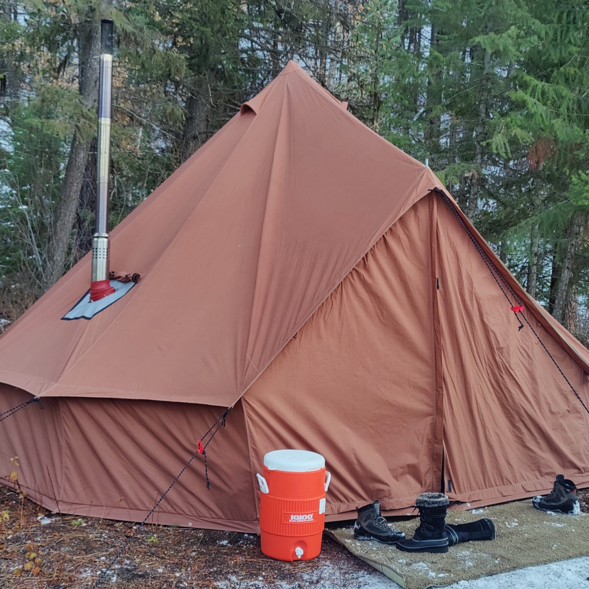 White Duck Outdoors Regatta Bell Tent in desert red with stove exhaust, showcasing its spacious, durable outdoor camping design.