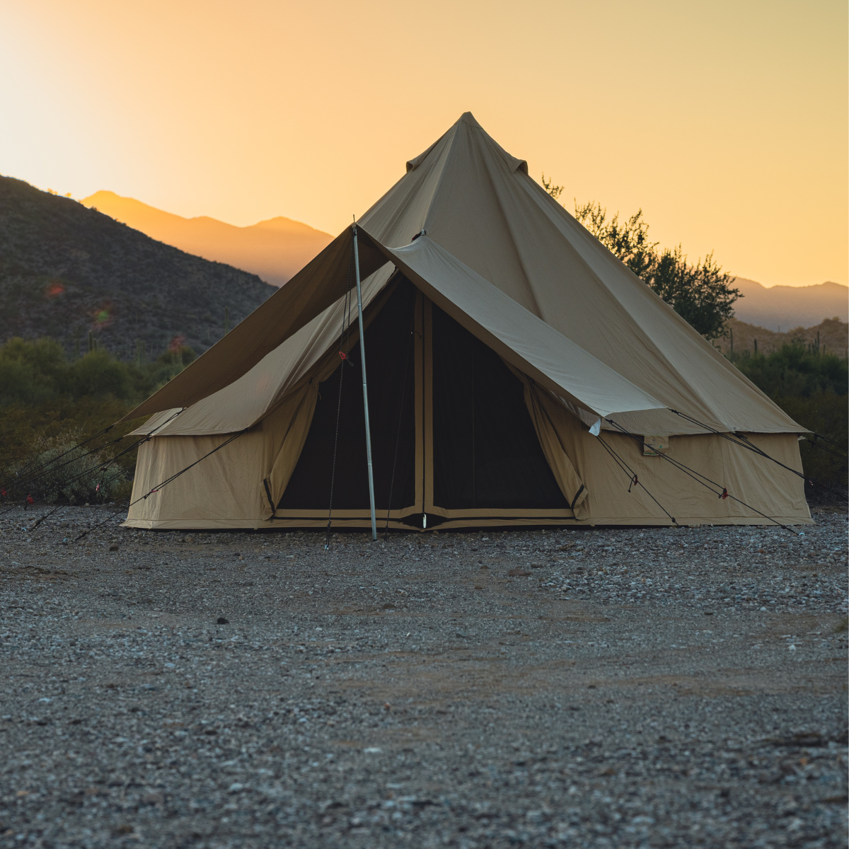White Duck Outdoors 13' Regatta Bell Tent in sandstone beige, featuring an awning and front view for camping or outdoor adventures.
