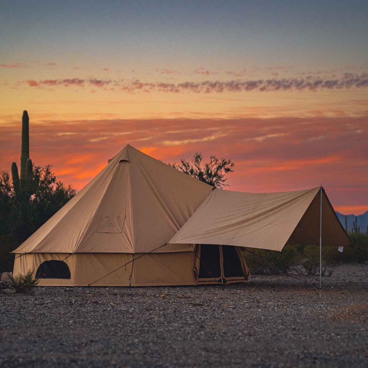 Sandstone beige Regatta awning attached to a White Duck Outdoors bell tent, providing shaded outdoor shelter.