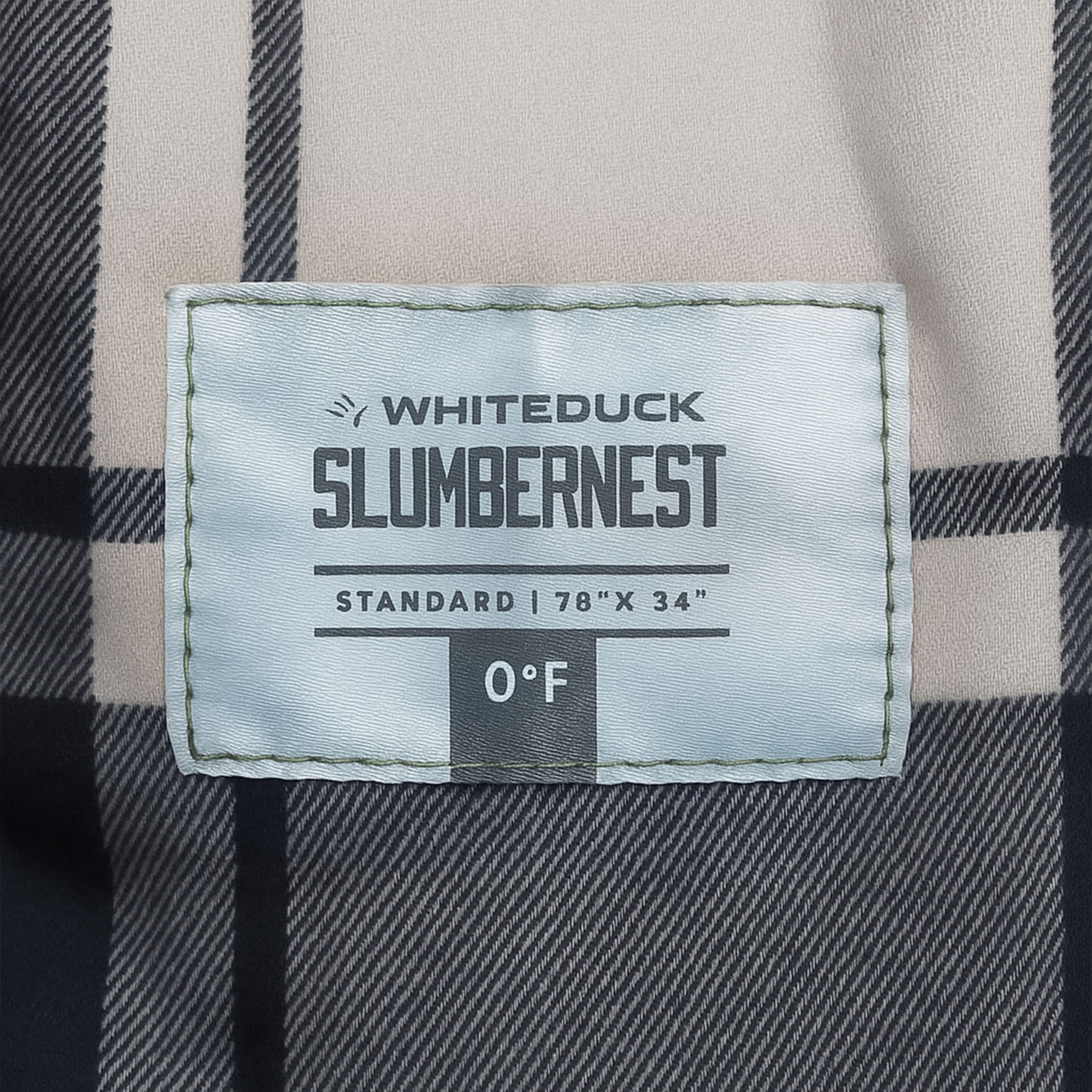 White Duck Outdoors Slumbernest™ sleeping bag in a camping scene, showcasing its 20°F insulation for cold weather camping.