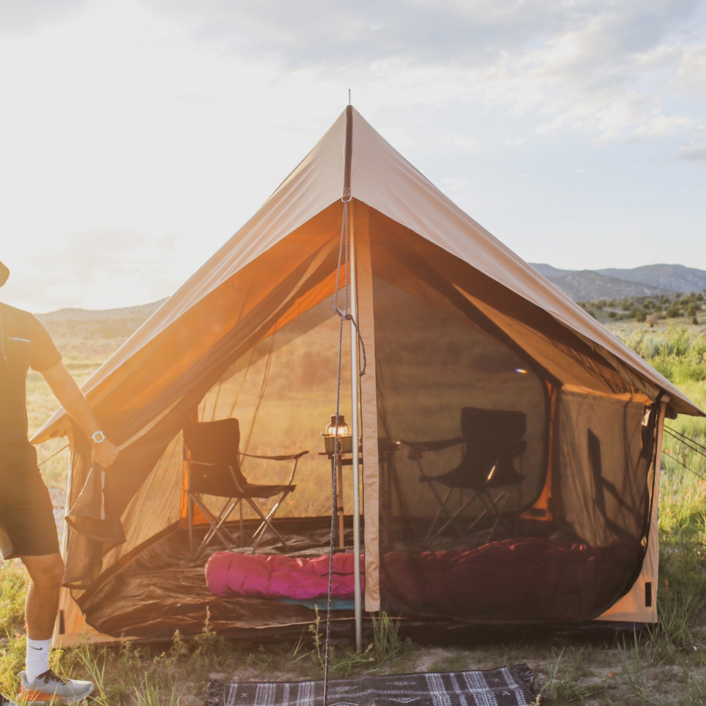 White Duck Outdoors Rover Scout Tent partially open in sunlight, showcasing mesh panels and durable outdoor camping design.