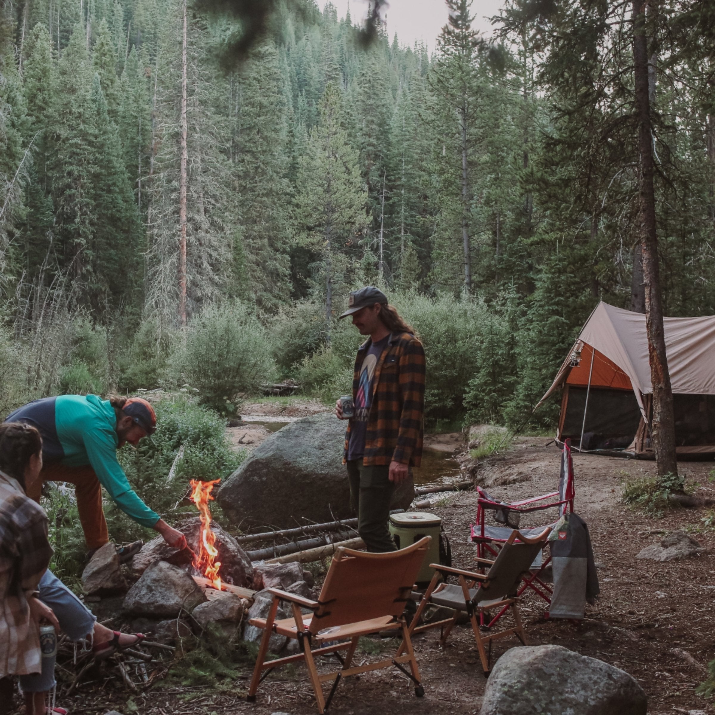 White Duck Outdoors Rover Scout Tent set up in a forest, showcasing a durable camping tent for outdoor adventures.