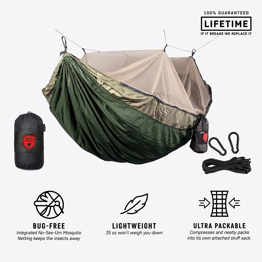 GrandTrunk Skeeter Beeter Pro mosquito net hammock hanging in a natural outdoor setting, providing shelter and protection from insects.