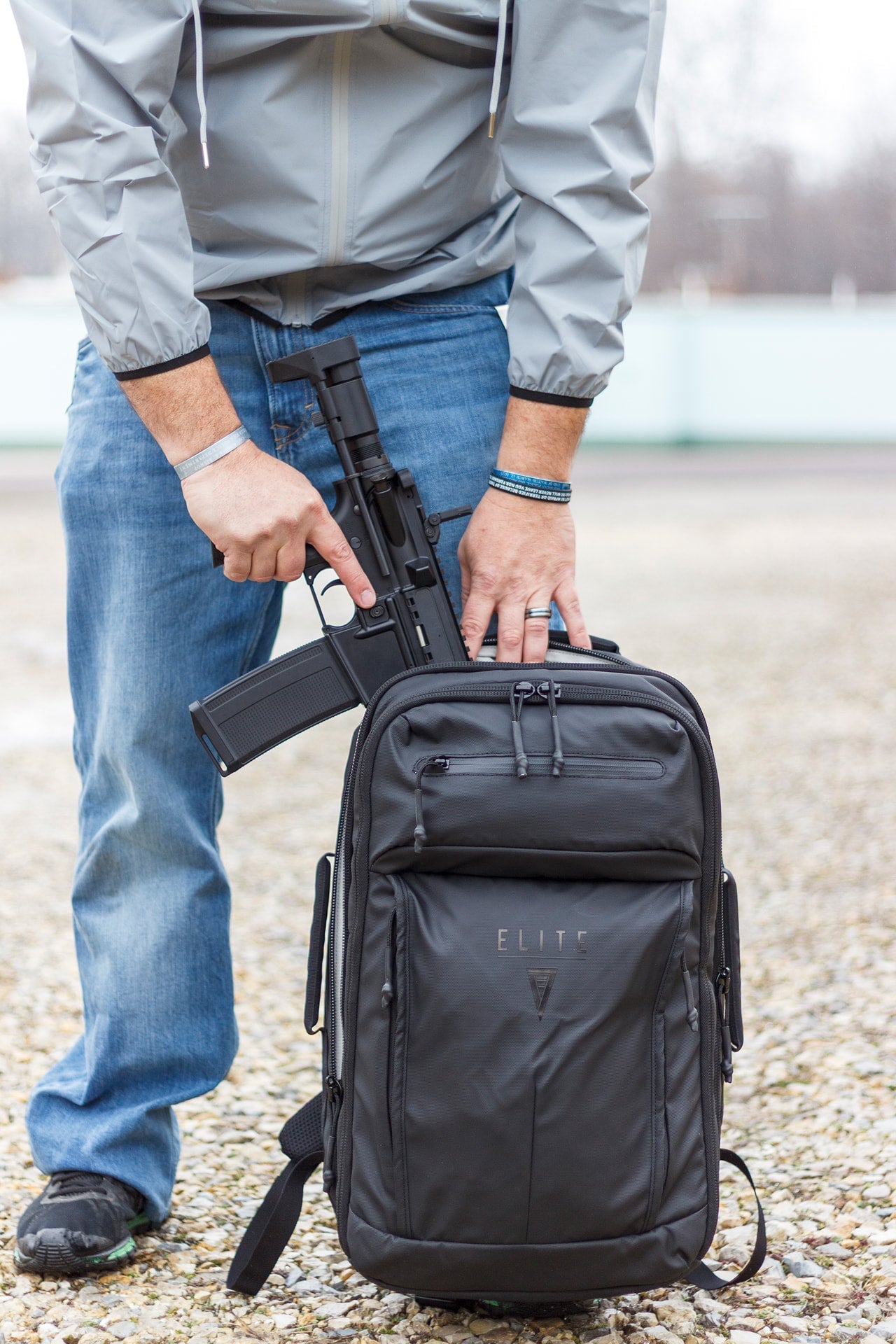 Elite Survival Systems STEALTH SBR Backpack in black, showcasing front pocket and durable straps in outdoor setting.