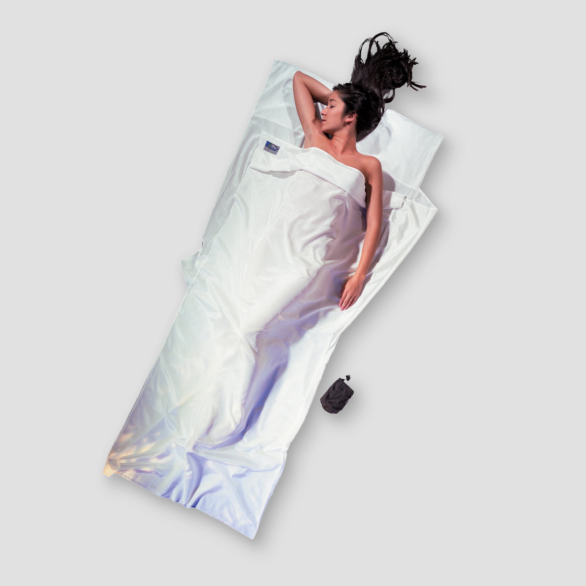 COCOON TravelSheet™ in Silk Egyptian Cotton, showcasing its smooth texture and elegant design for travel comfort.