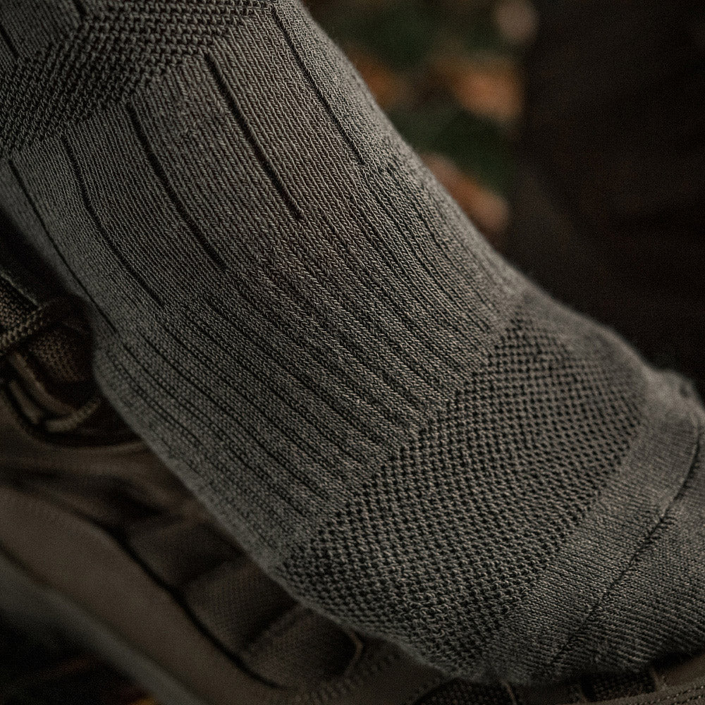 M-TAC mid calf tactical army socks featuring a durable design and comfortable fit for outdoor activities.