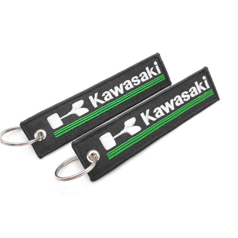 Embroidered motorcycle keychain decor featuring Bean's Moto Booth brand logo on a colorful fabric background.
