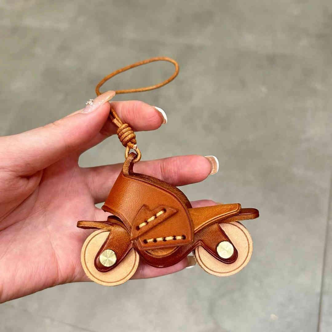 Handcrafted genuine leather motorcycle pendant decor by Bean's Moto Booth, featuring detailed leather craftsmanship and moto-inspired design.