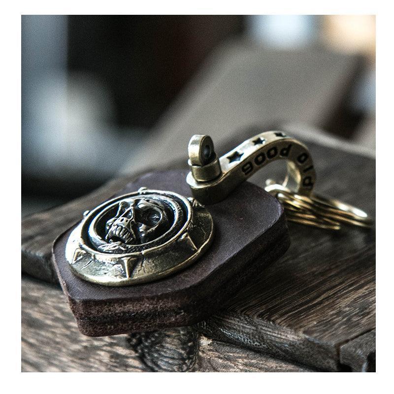Handcrafted leather heavy metal motorcycle keychain with decorative design from Bean's Moto Booth, featuring detailed metal accents.