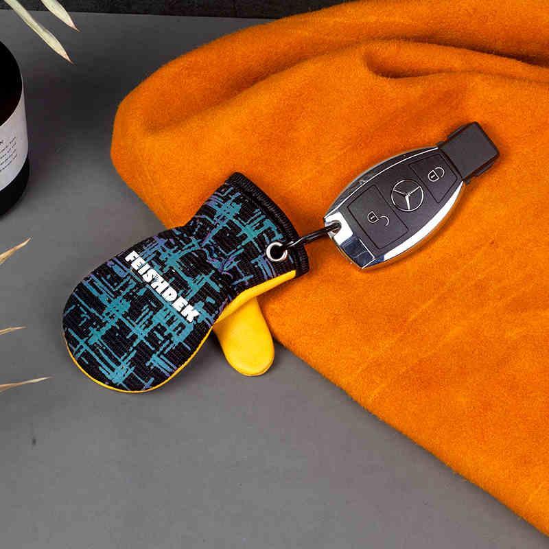 Vintage handcrafted leather motorcycle glove keychain with decorative metal accents, suitable for motorcycle enthusiasts.