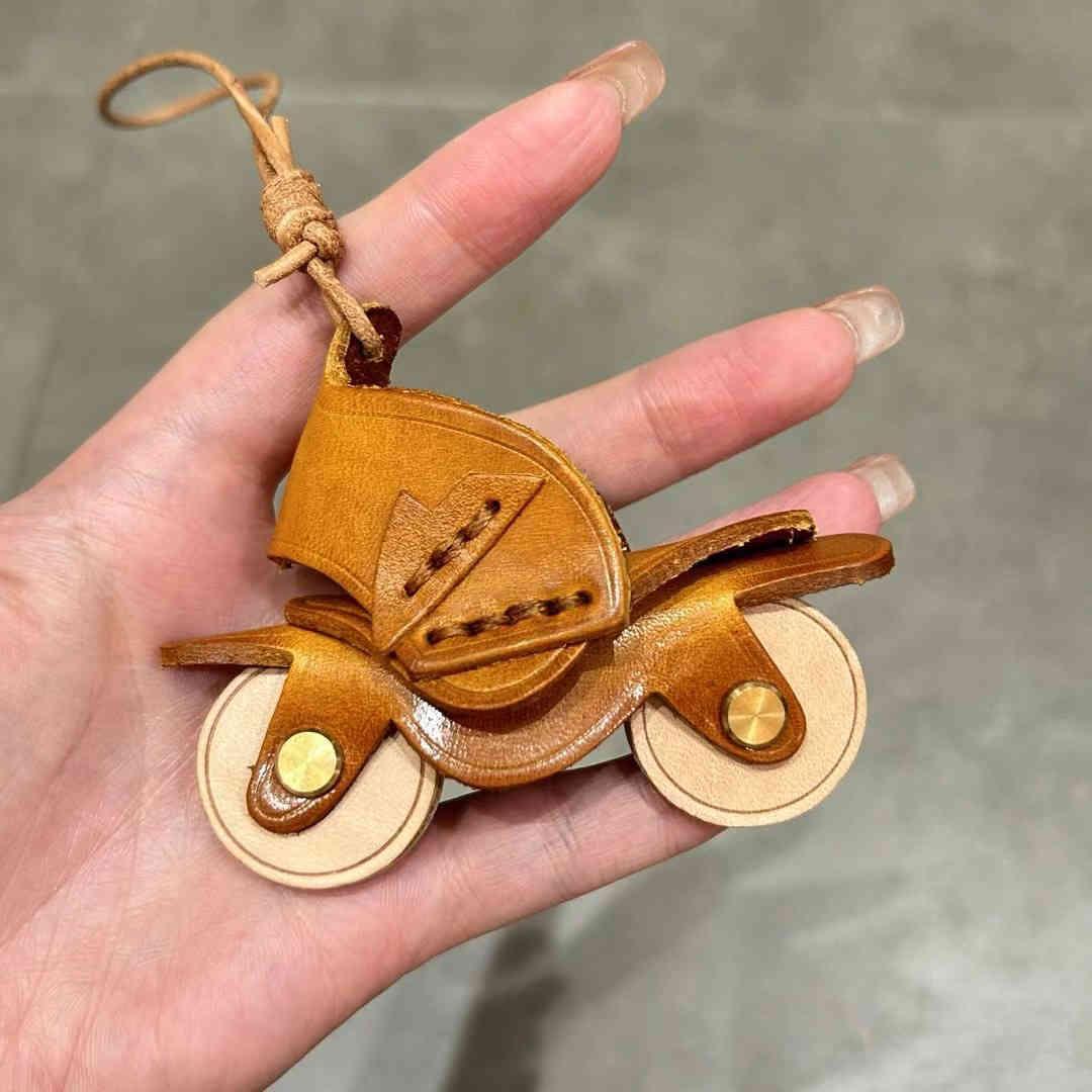 Handcrafted genuine leather motorcycle pendant decor with detailed stitching and rustic finish from Bean's Moto Booth.
