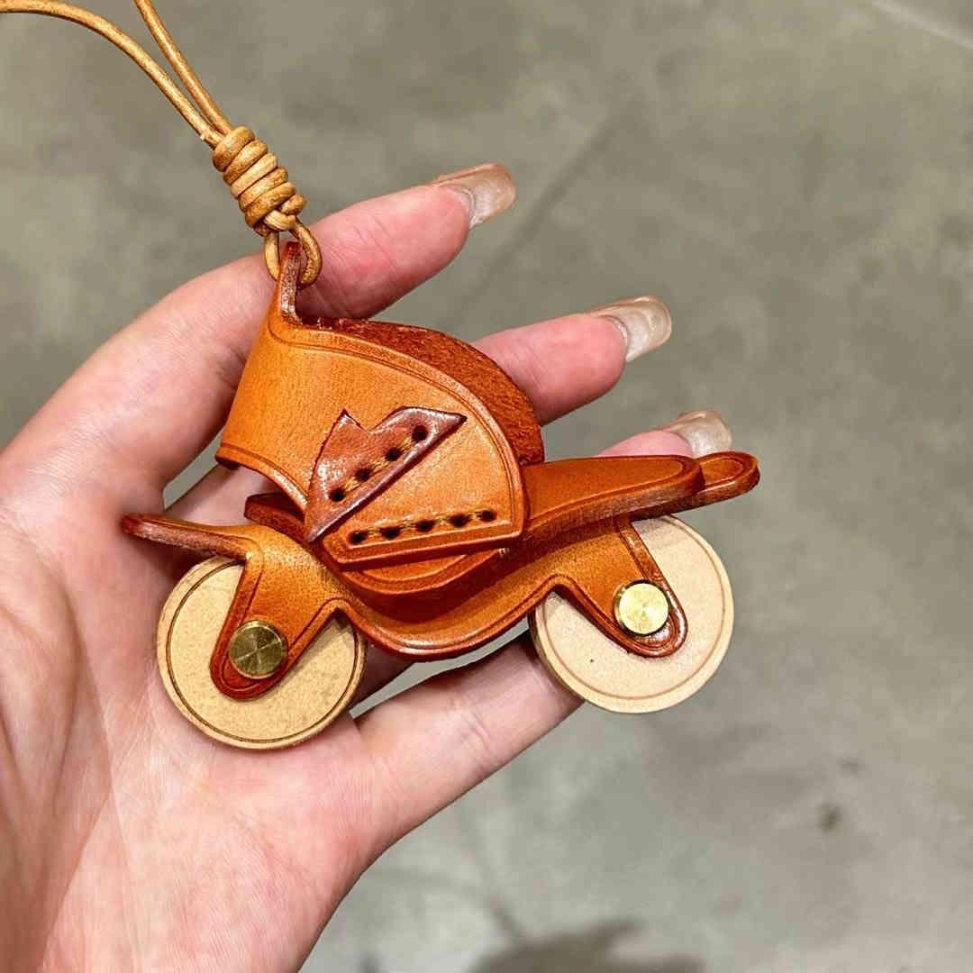 Handcrafted genuine leather motorcycle pendant used as decorative decor by Bean's Moto Booth, featuring detailed leather craftsmanship.
