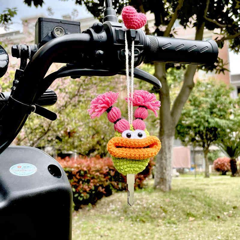 Decorative quirky cute motorcycle key cover from Bean's Moto Booth, designed to add fun to keysets with colorful motorcycle imagery.