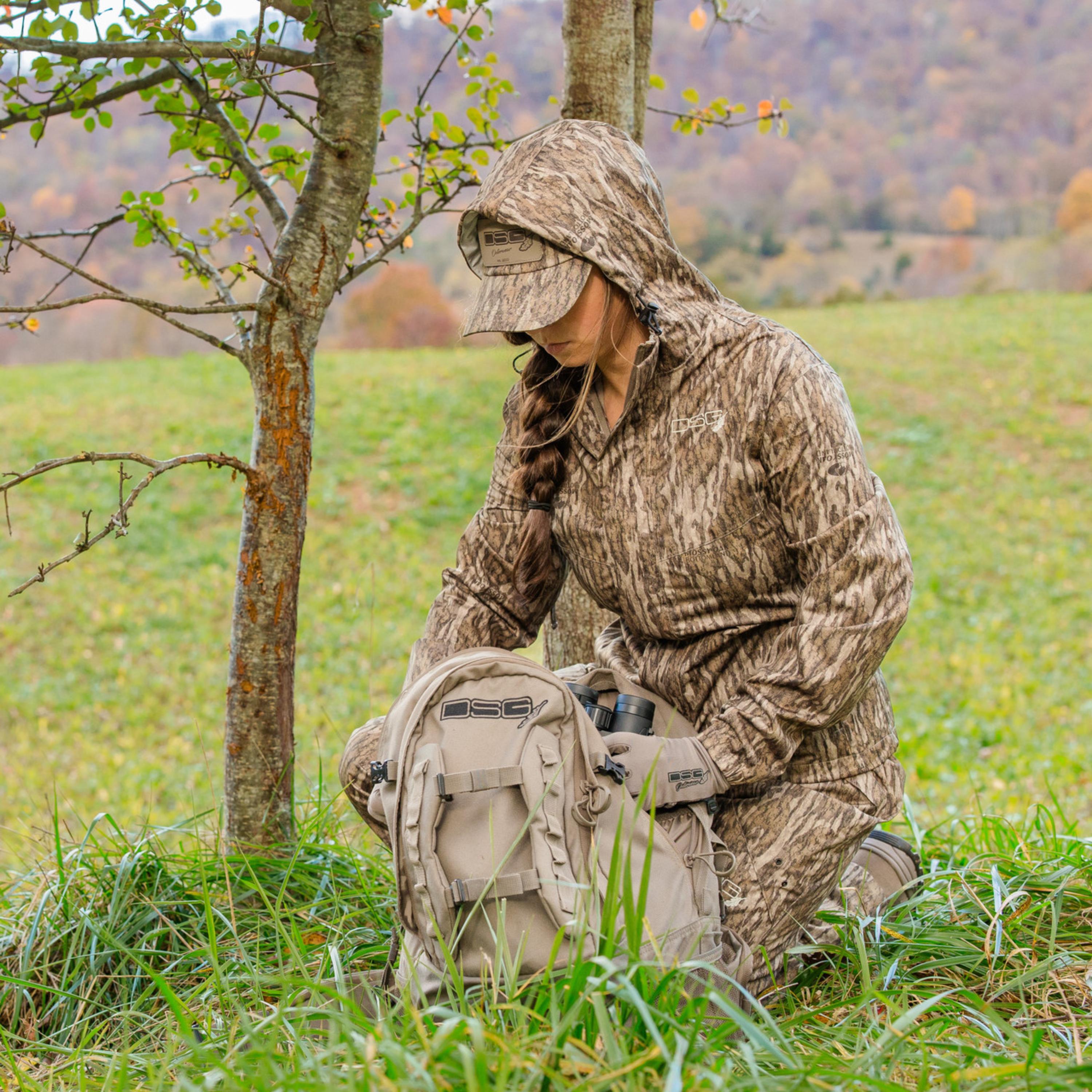 Blue DSG OUTERWEAR Nova rain jacket with hood and waterproof material, shown on a hanger against a neutral background.
