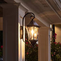 Black outdoor farmhouse solar wall light with 150 lumens, mounted on a wall, ideal for outdoor solar lighting.