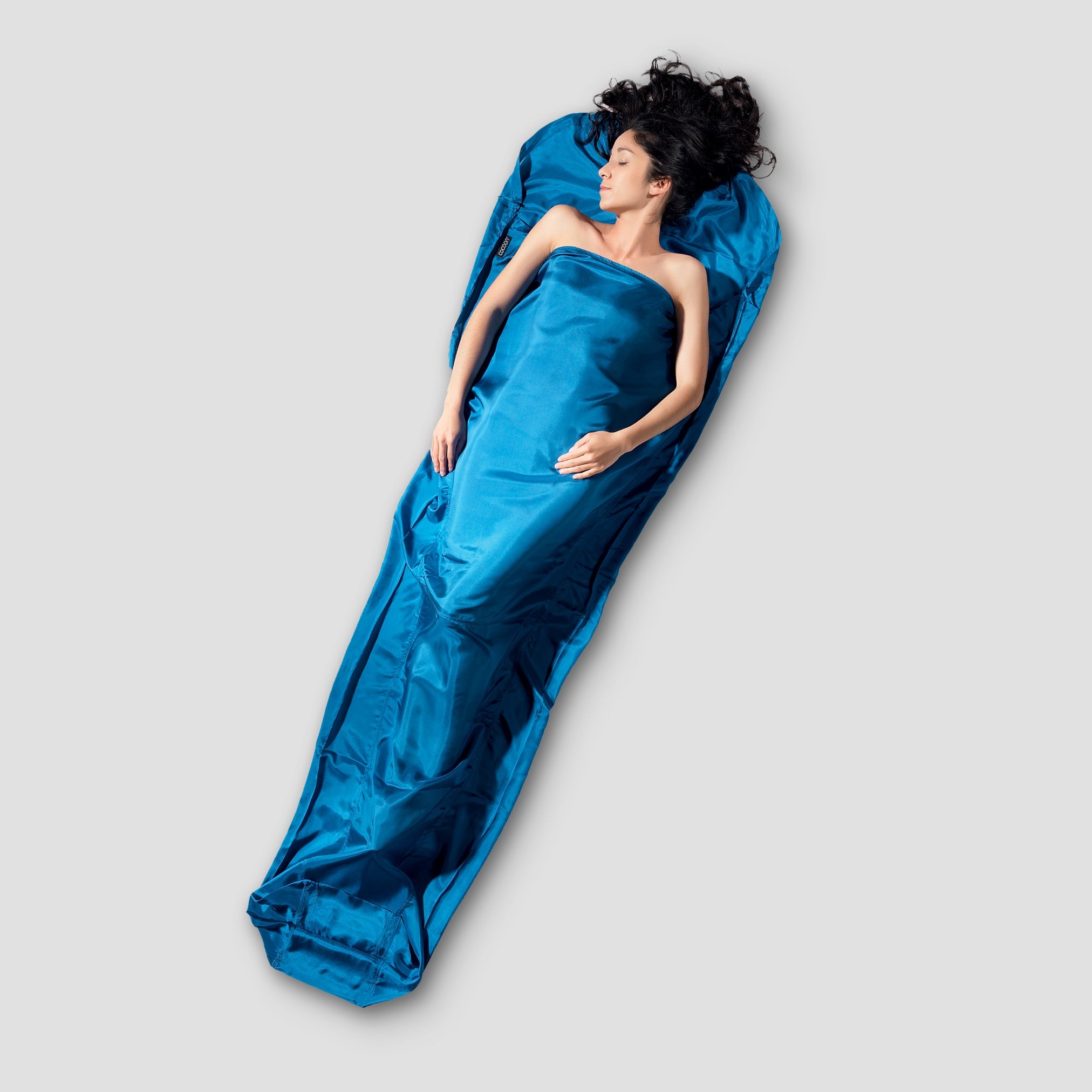 COCOON MummyLiner™ Silk in a soft, luxurious texture, showcasing its elegant drape and lightweight design.