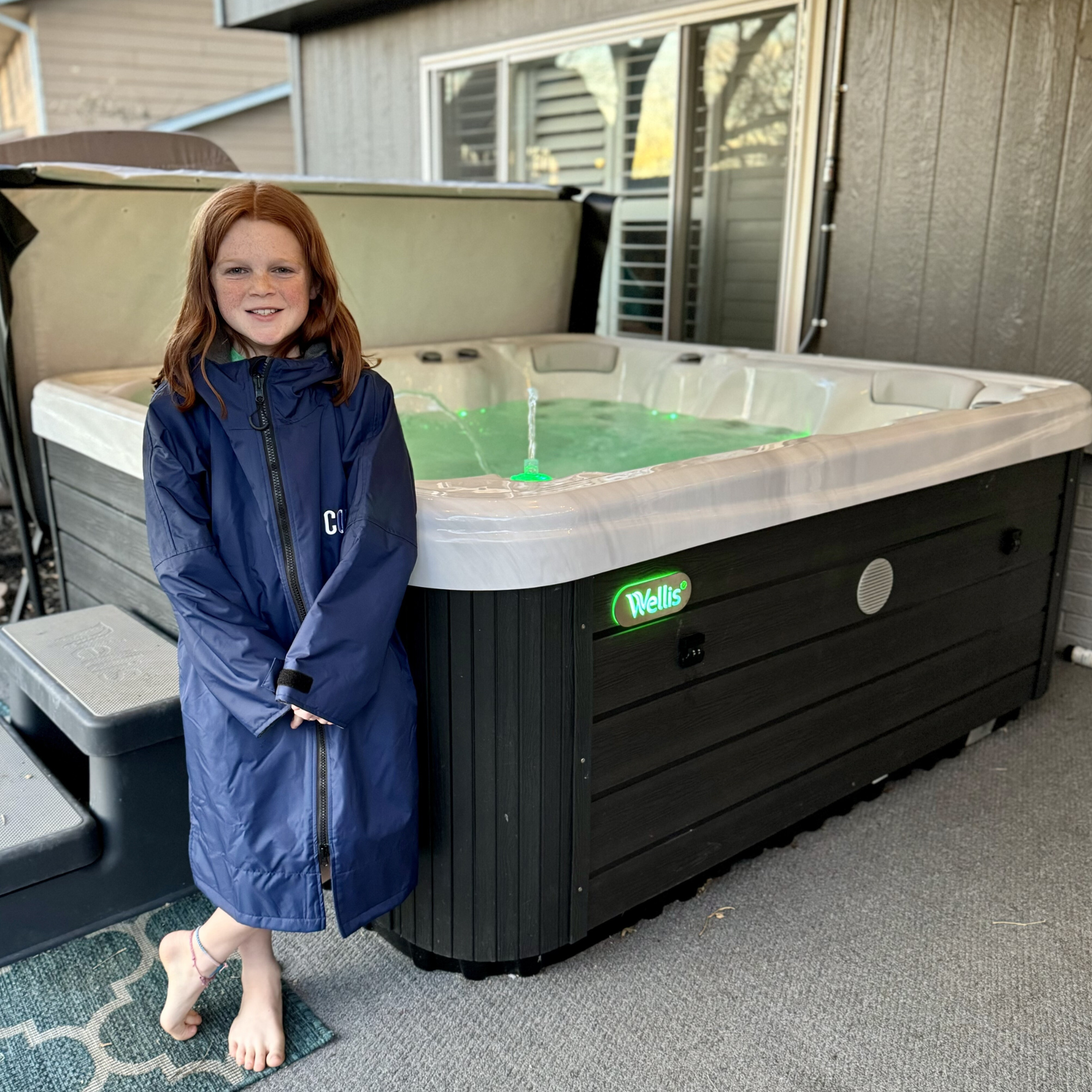 Navy blue waterproof swim parka by COR Surf, lightweight jacket designed for swimming and outdoor water activities.