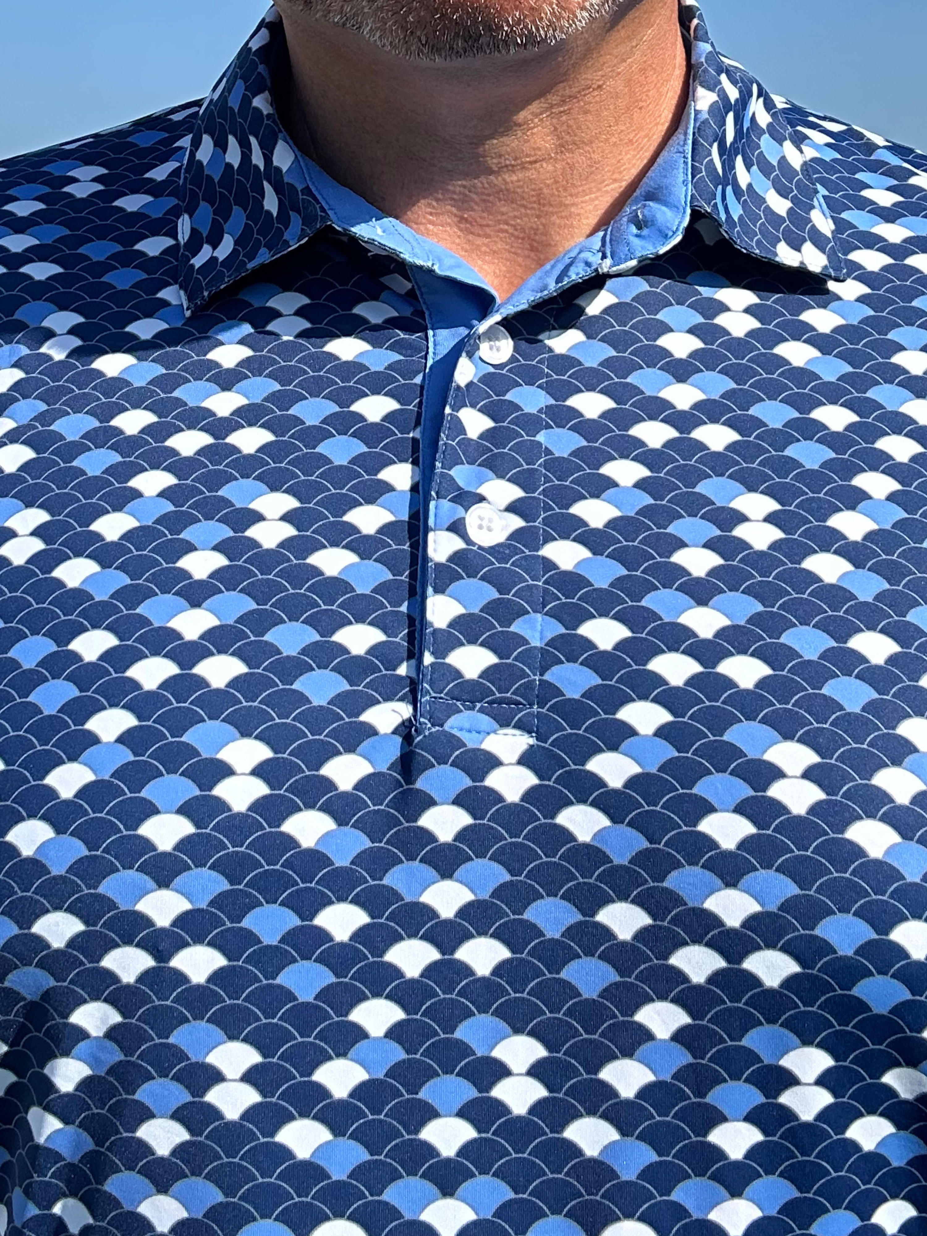 Close-up of White Water Life Scales Polo showcasing intricate scale pattern and soft fabric texture.