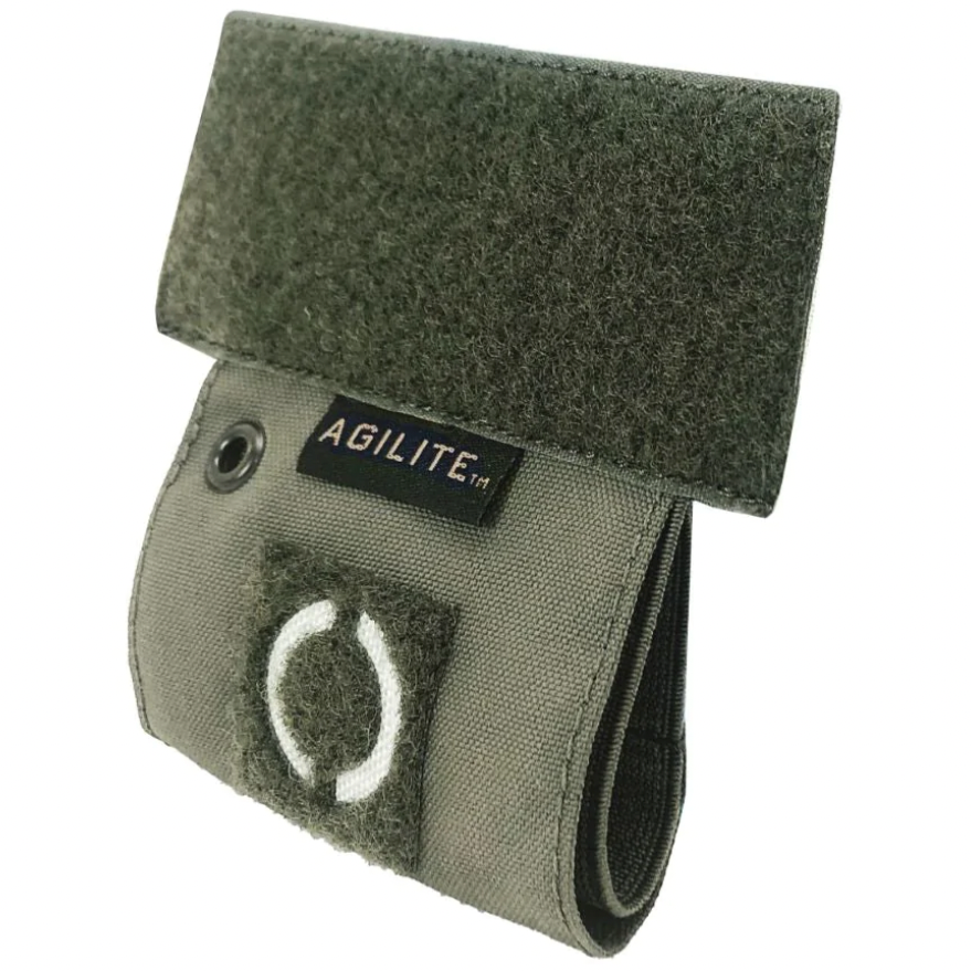 HCC Tactical tourniquet holder attached to tactical gear, durable black nylon with quick-release buckle for emergency medical use.