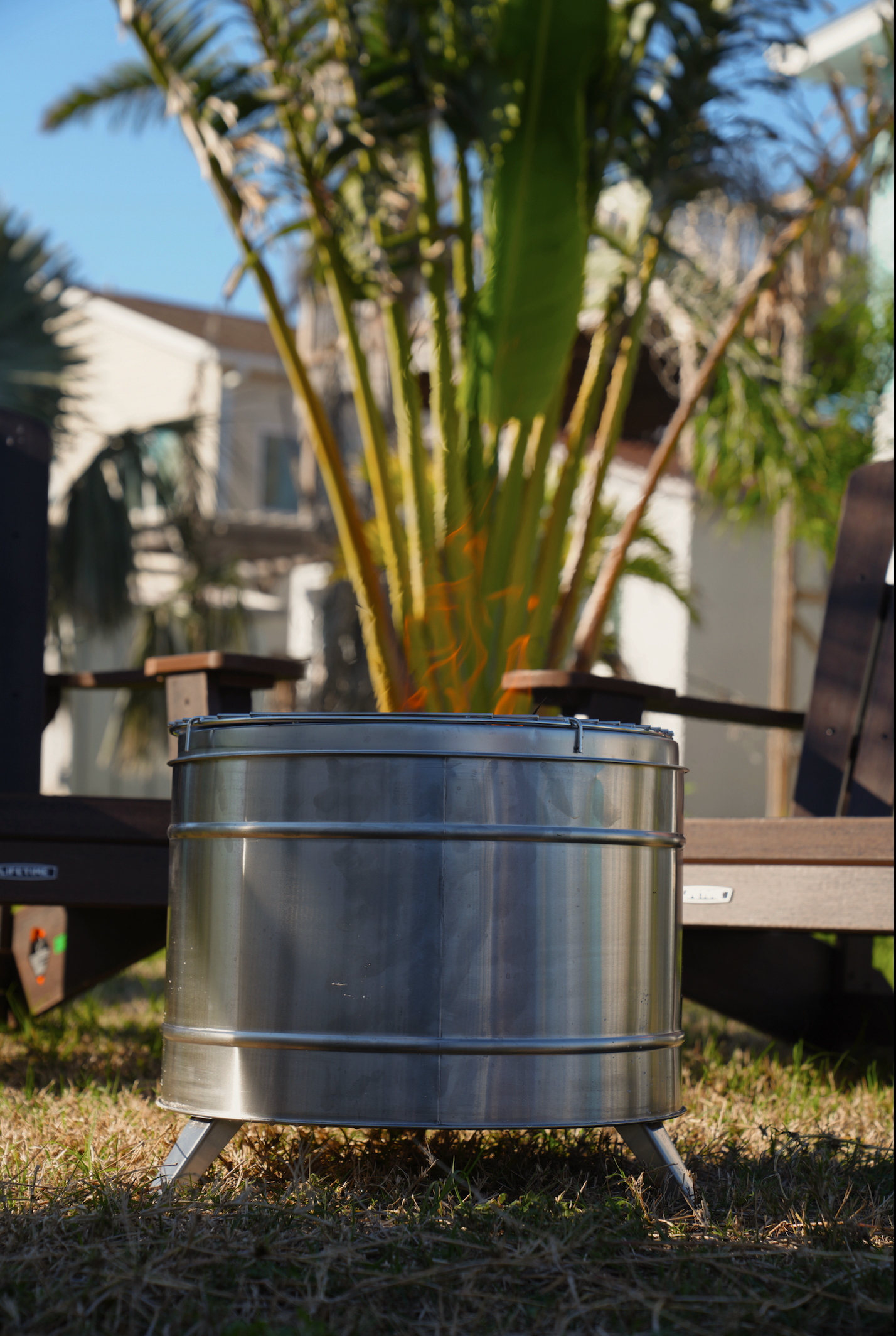 Large smokeless fire pit by North Shore Sauna with a modern design, showing a fire burning inside on a stone patio.