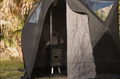 North Shore Sauna Nova 4 Sauna Tent Starter Package for four people set up outdoors in a natural setting.