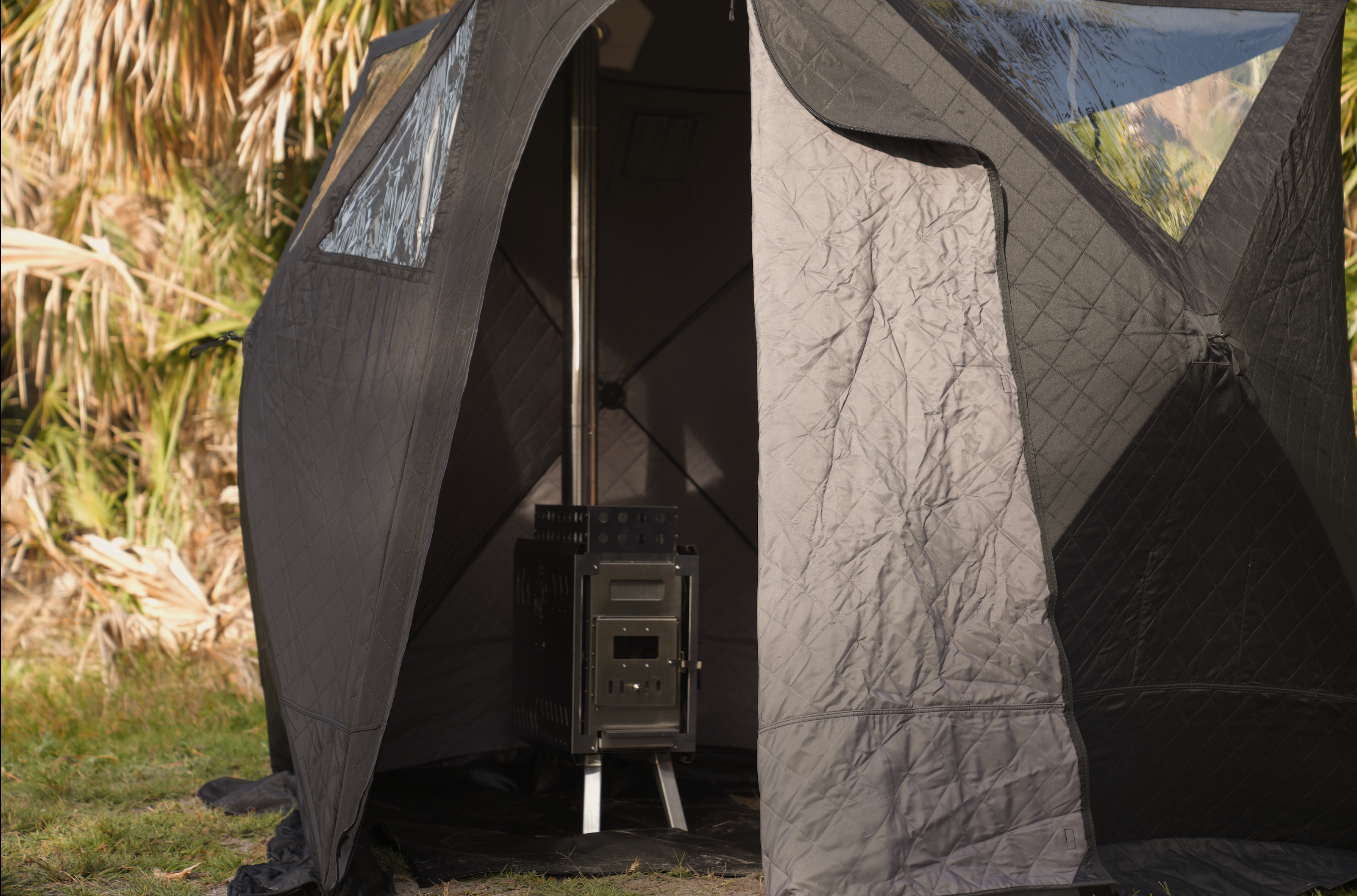 North Shore Sauna Nova 4 Sauna Tent Starter Package for four people set up outdoors in a natural setting.