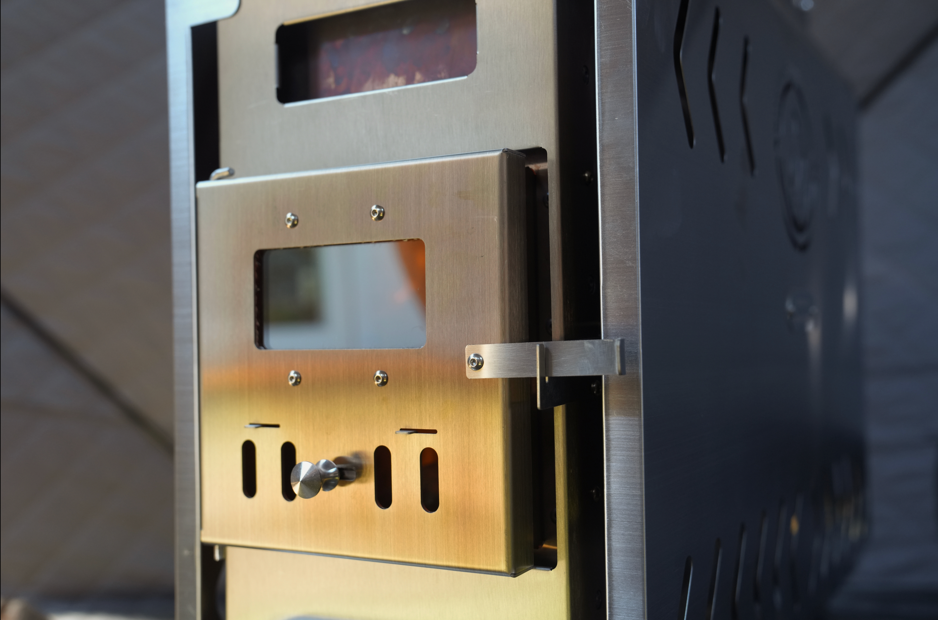 Portable North Shore Sauna tent wood stove in brushed stainless steel, designed for outdoor sauna use.