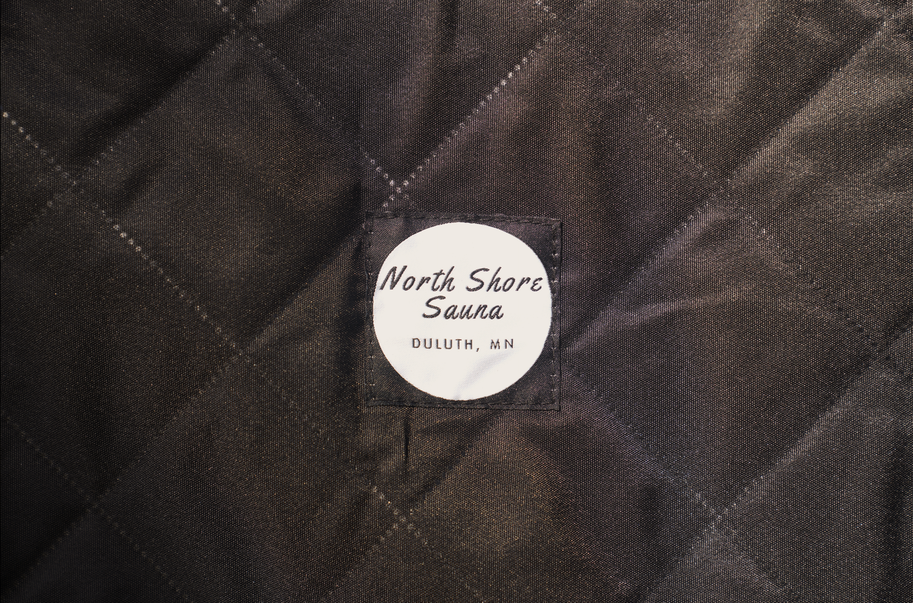 North Shore Sauna stove carrying bag in black, designed for easy transport and protection of sauna stoves.