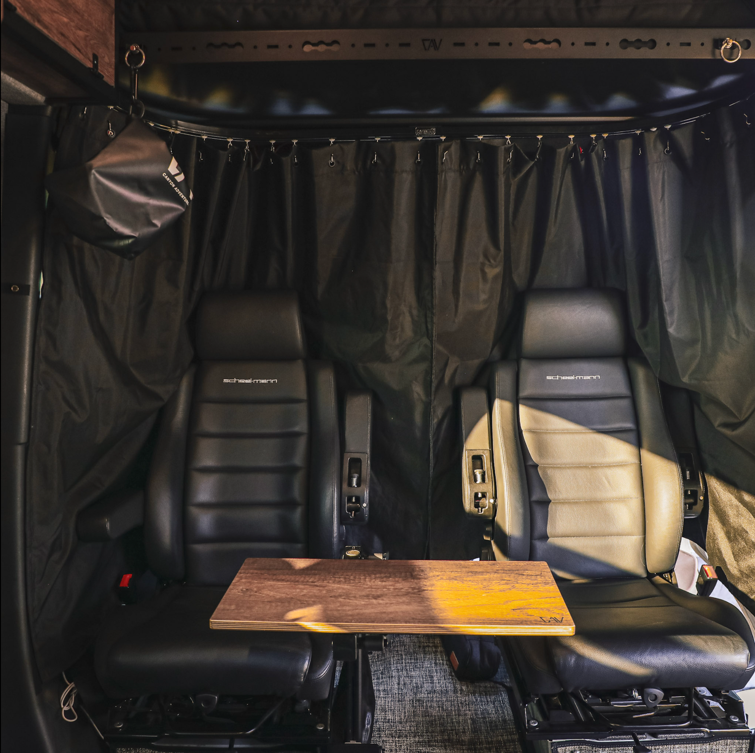 Canyon Adventure Vans CLIMA-SHADE™ Showtime Curtain attached inside van window, providing shade and privacy for outdoor adventures.
