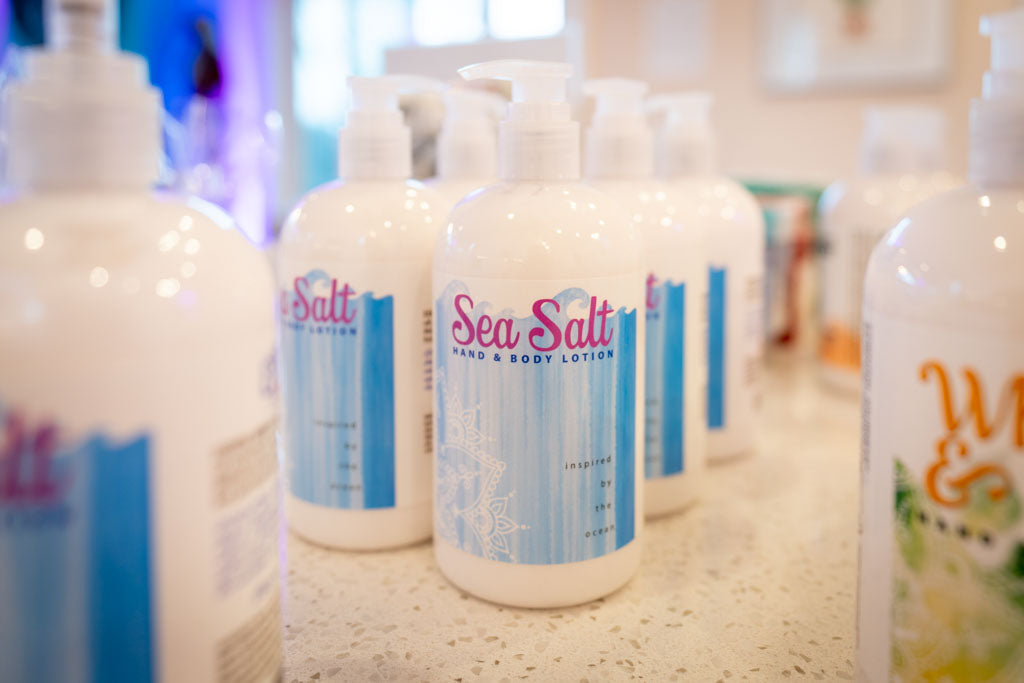 Essential Journeys sea salt hand and body lotion in a 16 oz container, creamy texture with natural sea salt exfoliants.