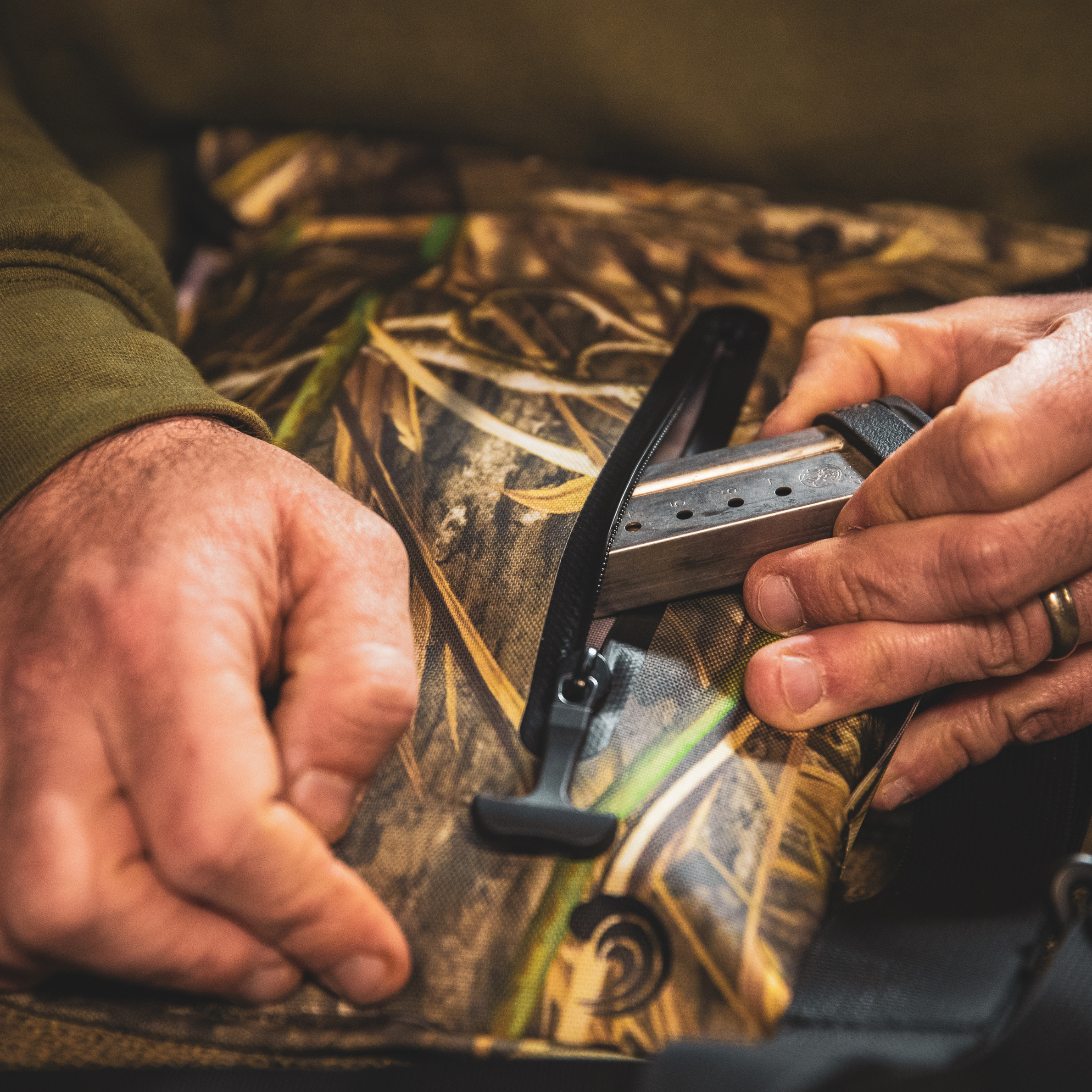 Auto-sealing waterproof floating pistol bag by Dry Pocket in shadow grass color, designed for secure firearm storage on water.