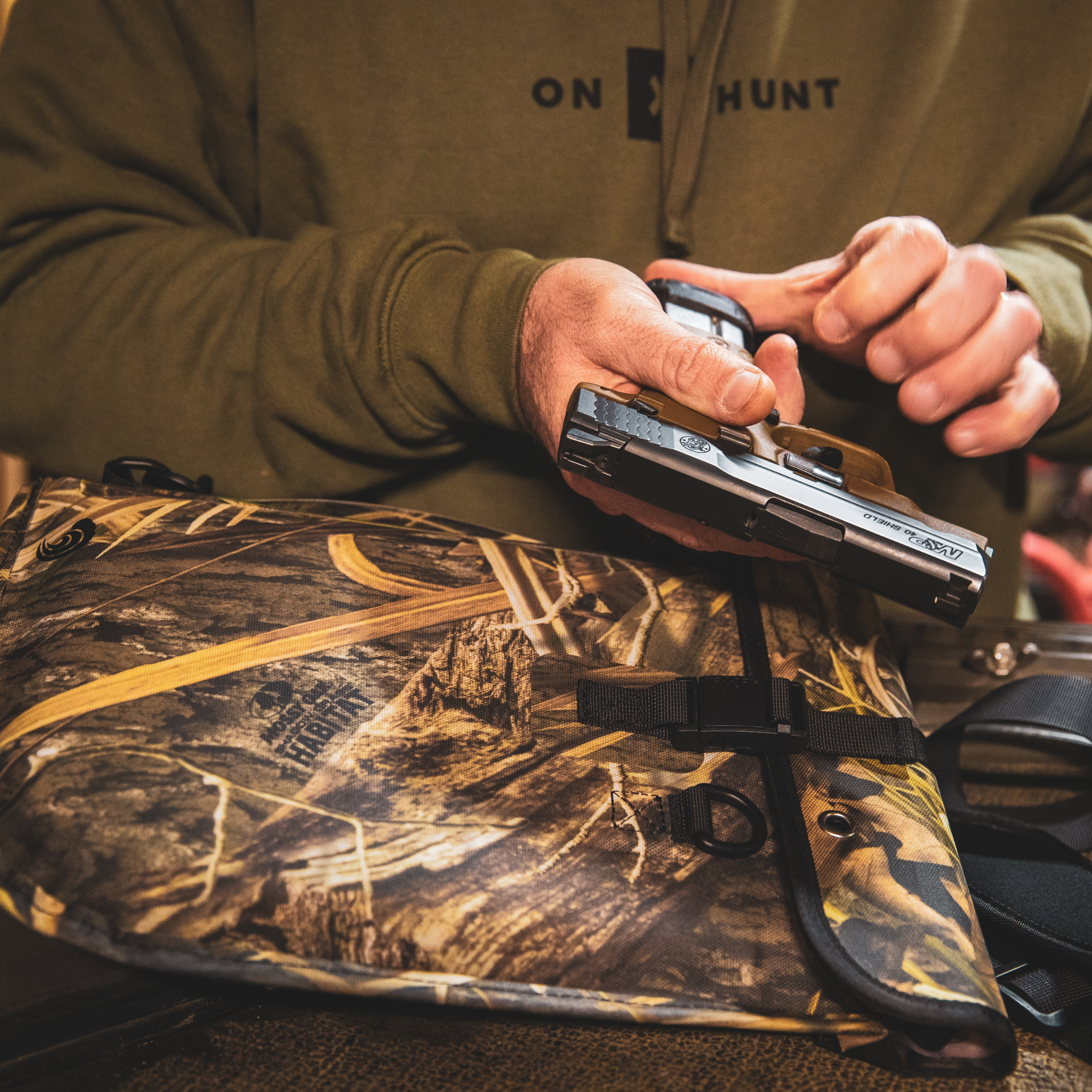 Auto-sealing Dry Pocket waterproof floating pistol bag in shadow grass color, designed for secure firearm storage.