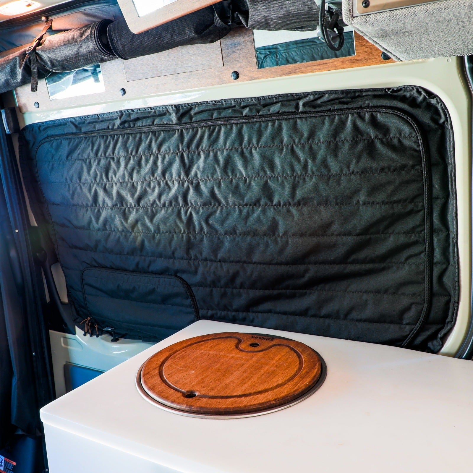 Canyon Adventure Vans CLIMA-SHADE insulated sliding door window cover for Storyteller Overland Mode, providing privacy and insulation.