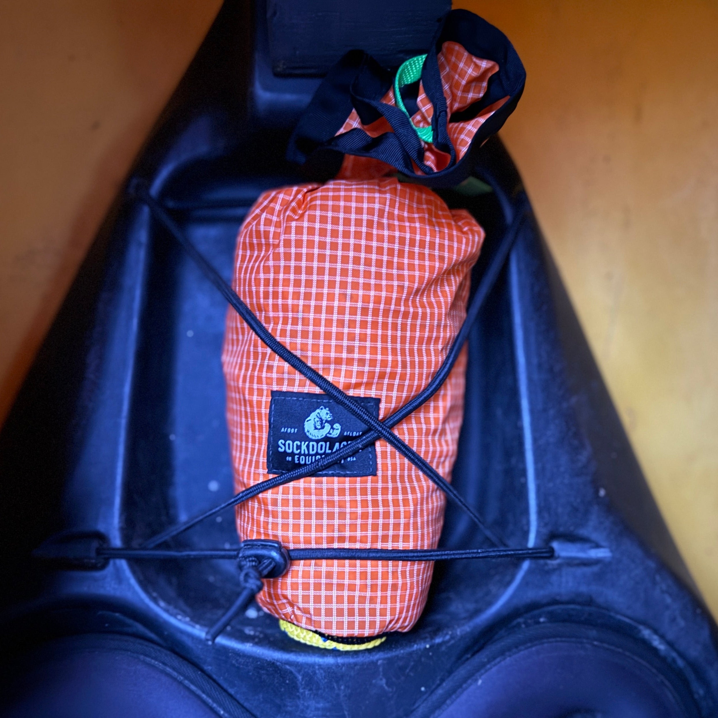 River Hardware Flare 55' throw bag with bright orange sockdolager in a kayak for rescue and safety training.