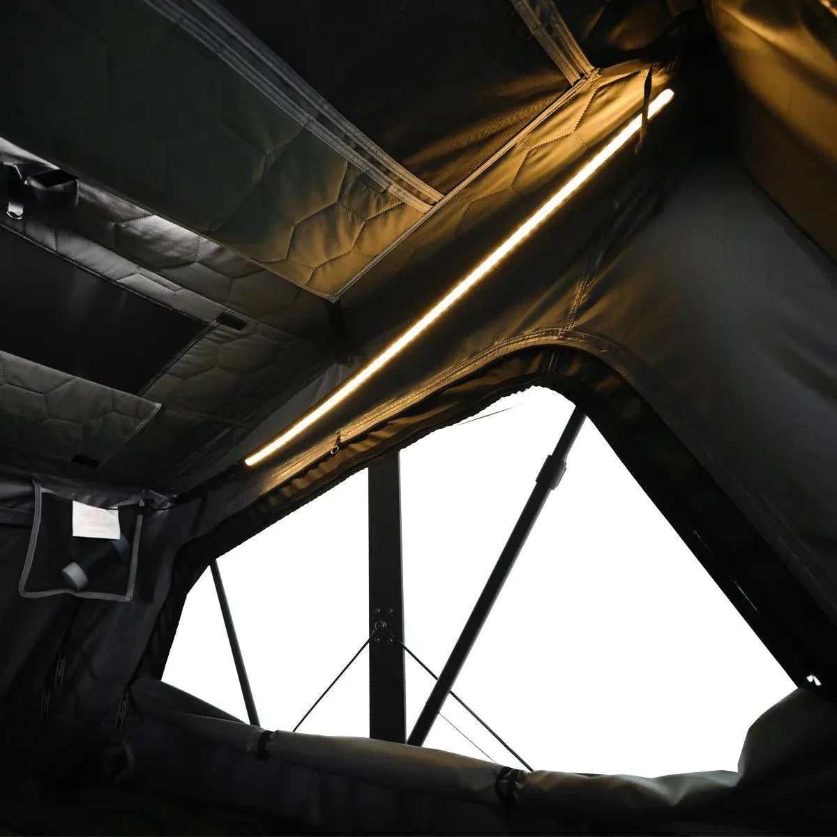 Wild Land OrthFrame Max roof top tent mounted on a vehicle, showcasing rugged overlanding gear for outdoor adventures.