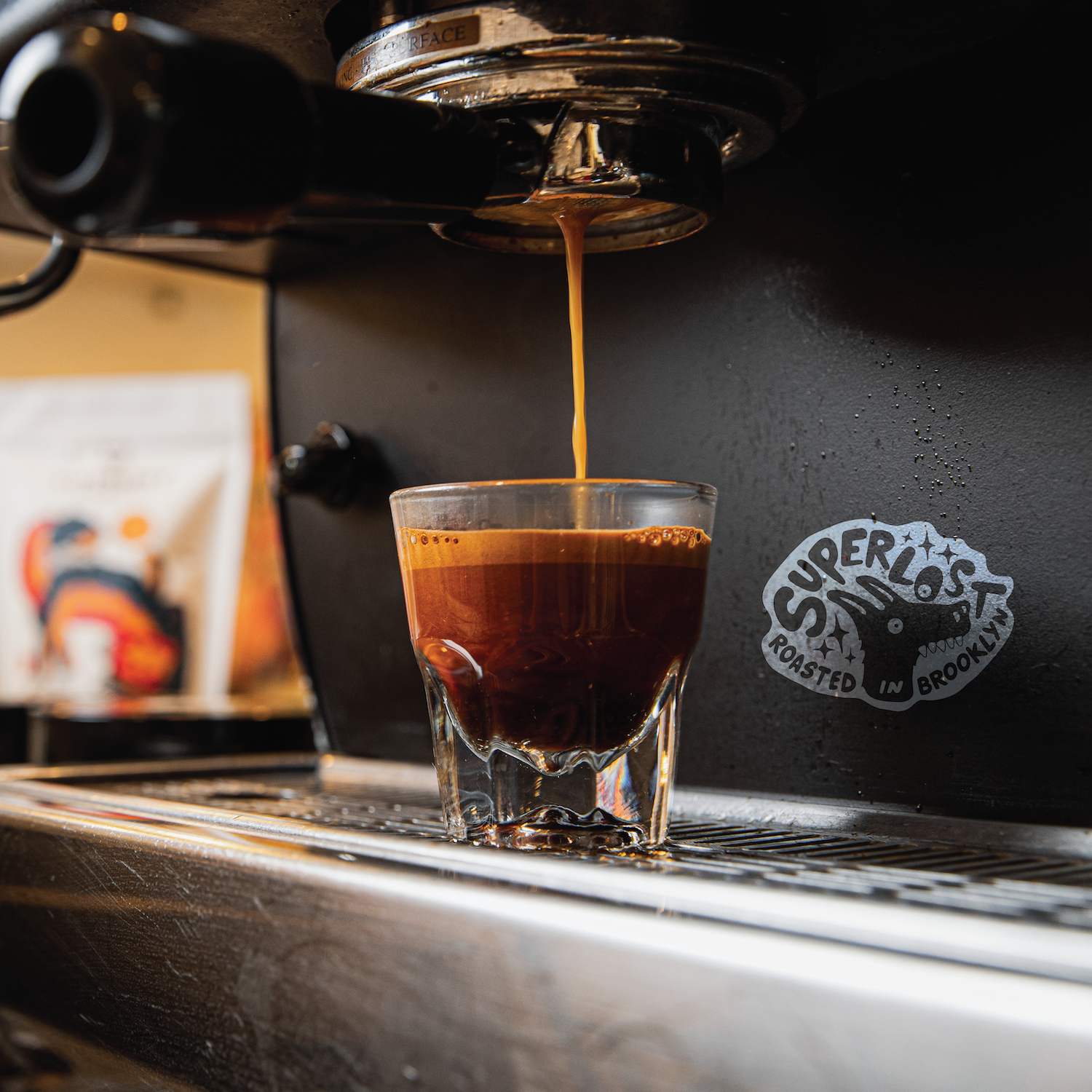 Close-up of a Supernova Espresso shot being pulled from a Superlost Coffee espresso machine with rich crema on top.