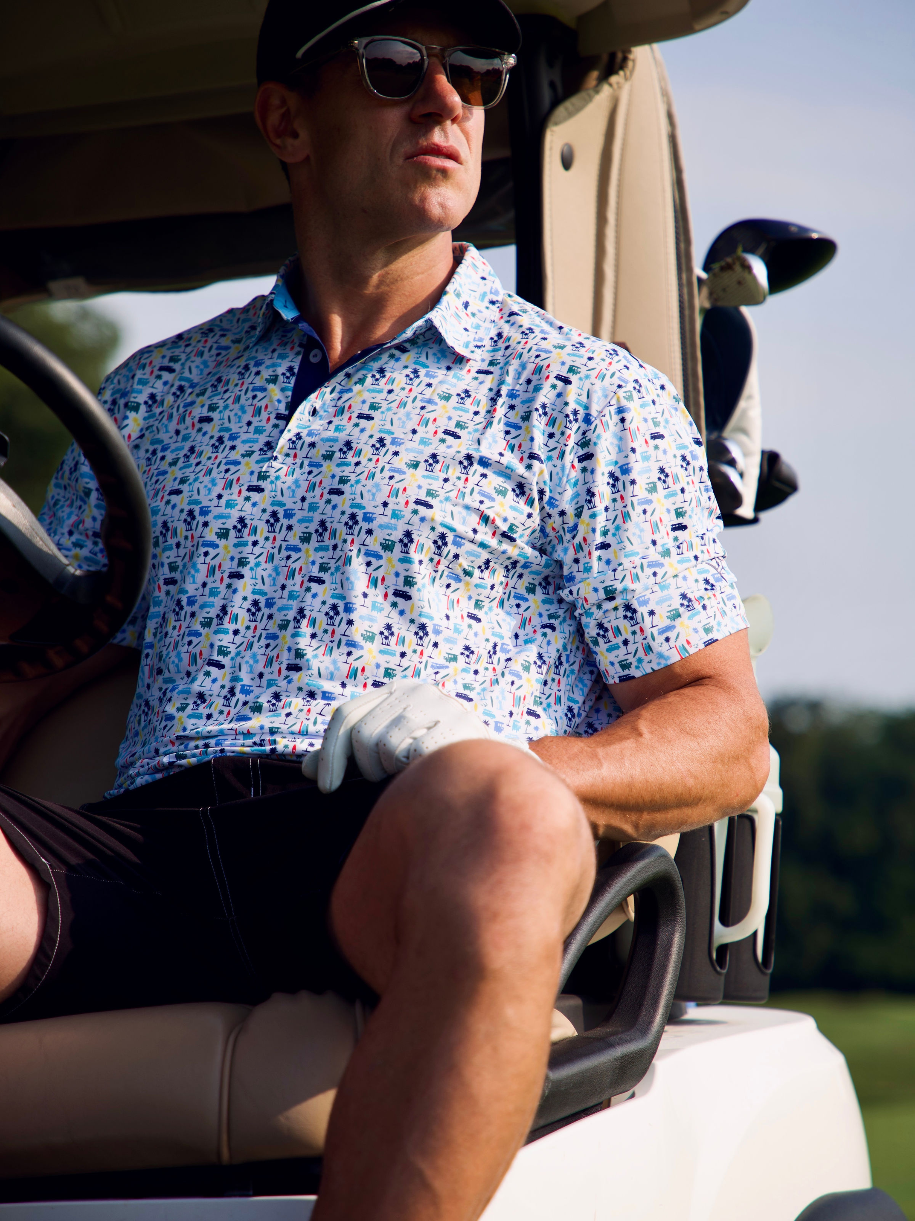 White Water Life Surfs Up Polo shirt shown on a surfside cart, featuring a casual polo design ideal for beach and summer wear.