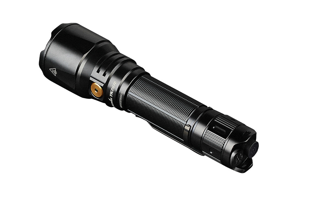 Fenix TK26R Tactical LED Flashlight with 1500 lumens, showcasing its sleek design and powerful beam in a dark setting.