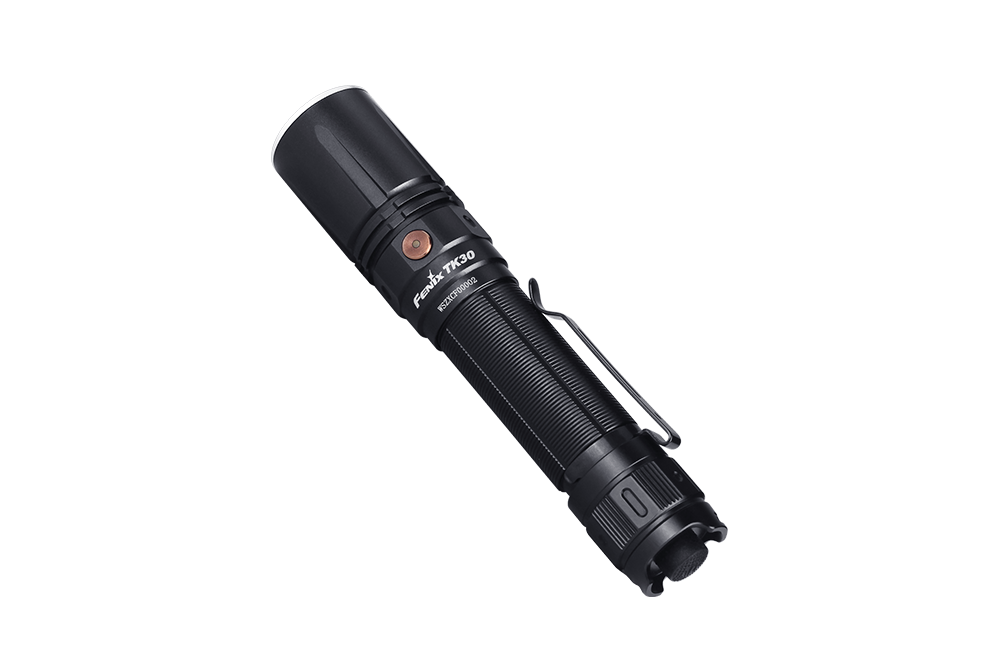 Fenix TK30 tactical flashlight with white laser LED, showcasing its durable design and bright beam in a dark setting.