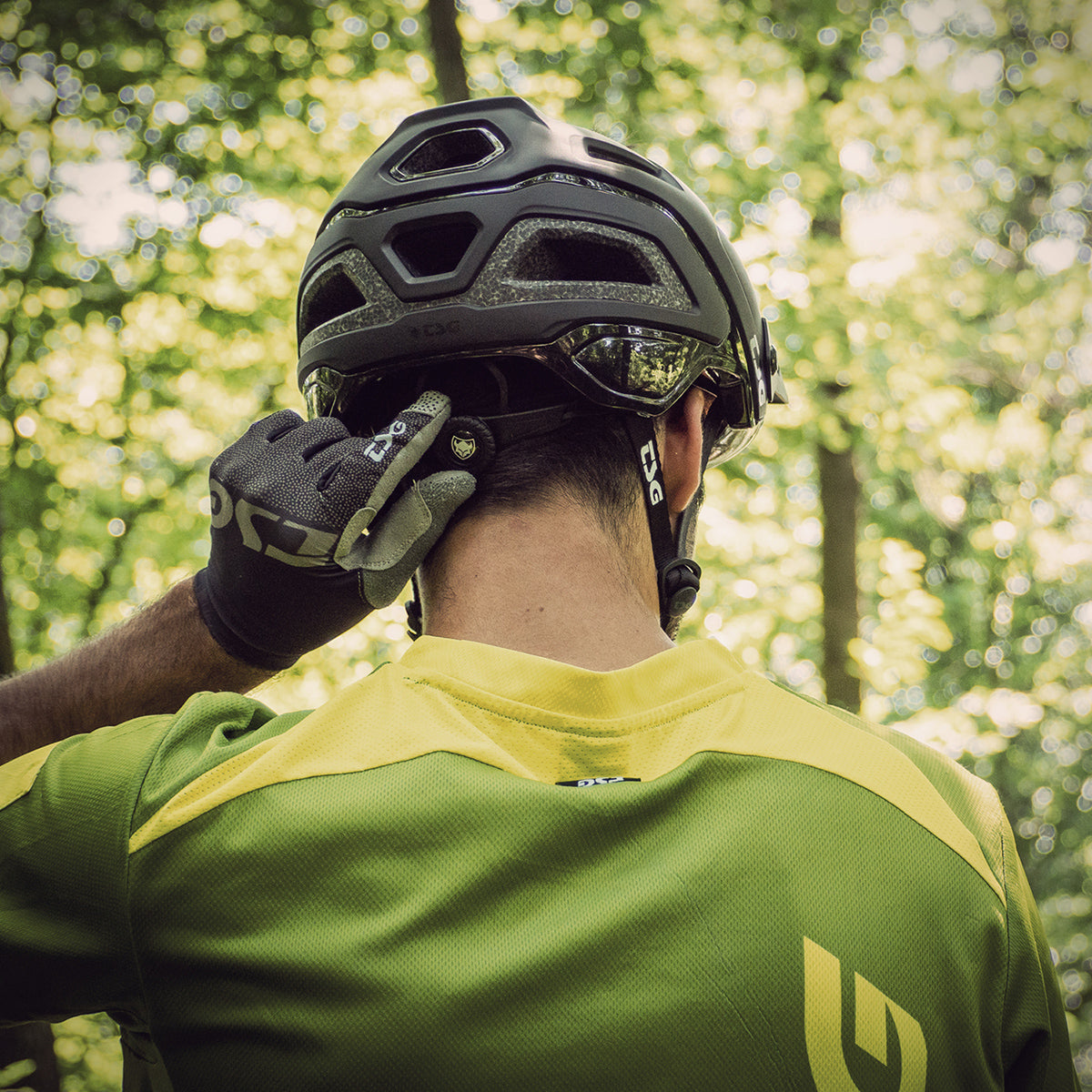 ZEITBIKE TSG helmet in satin black, designed for safety and style, shown in a lifestyle setting with a smooth, solid color finish.