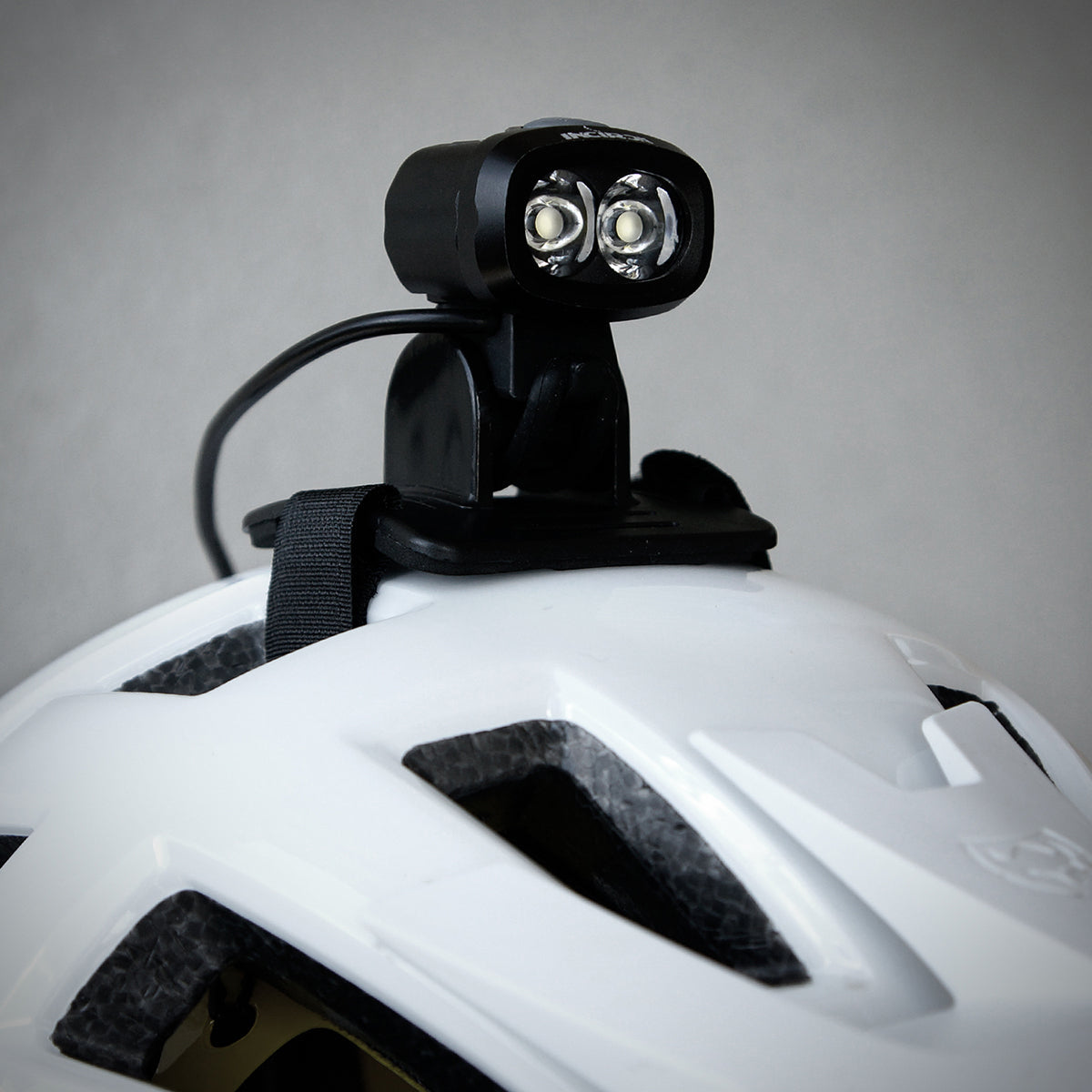 Satin black TSG helmet by ZEITBIKE with sleek design and adjustable strap, shown from a side angle.