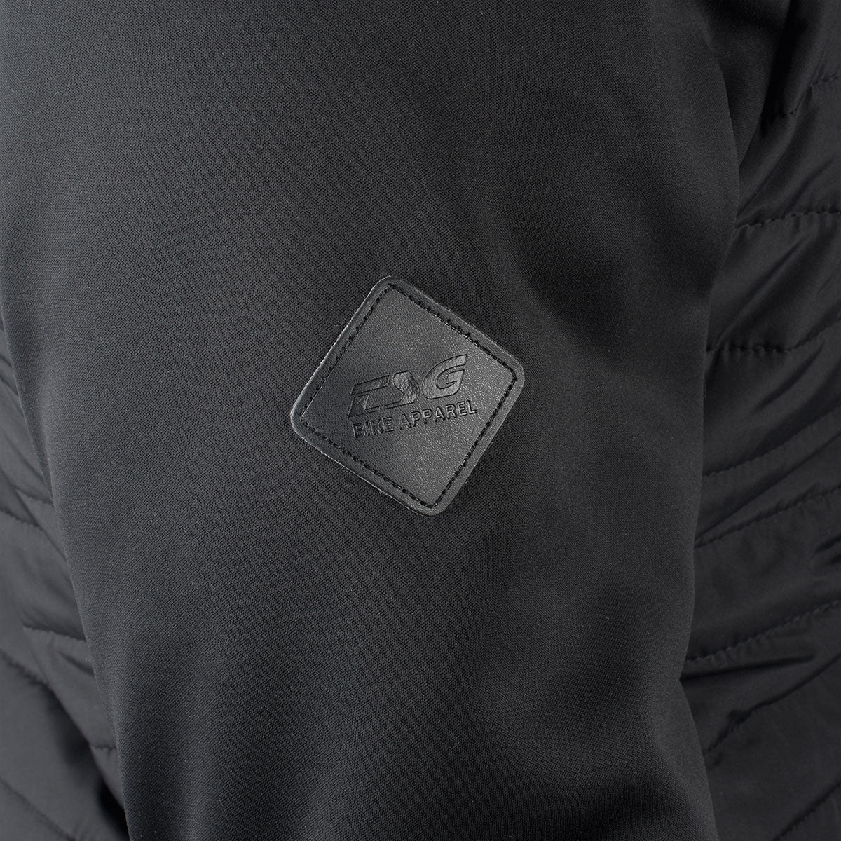Black TSG insulation jacket by ZEITBIKE, showcasing the lightweight padded design and front zipper detail.