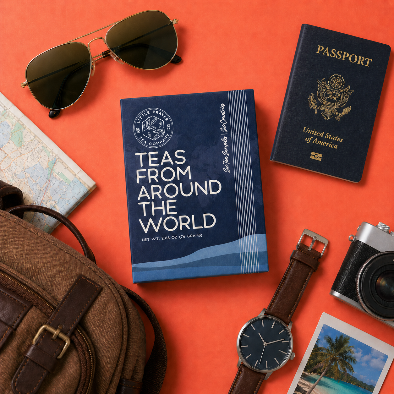 Assorted teas from around the world displayed in a box, featuring various colorful tea packages from Little Prayer Tea Company.