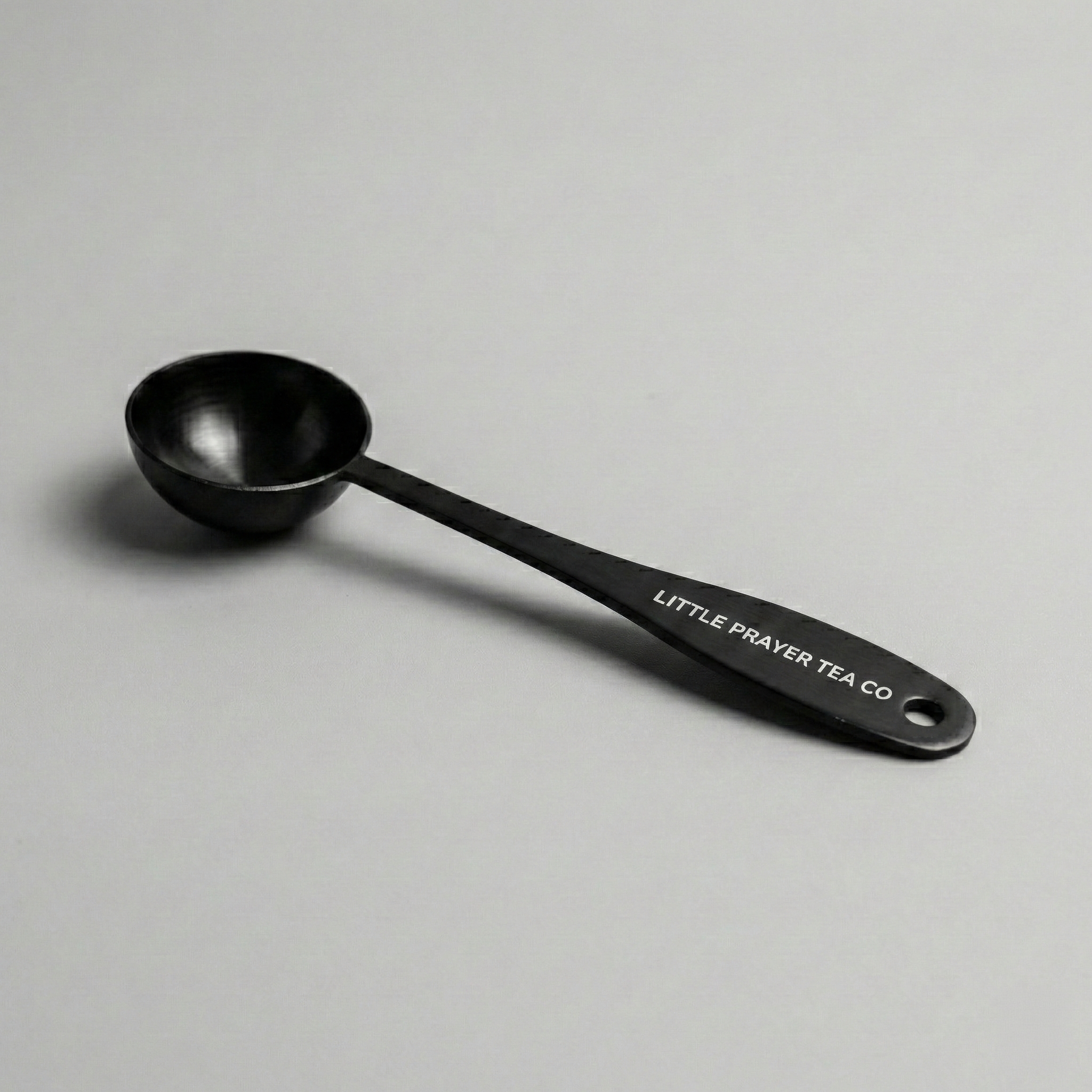 Little Prayer Tea Spoon from Little Prayer Tea Company, elegantly designed for measuring loose tea leaves.